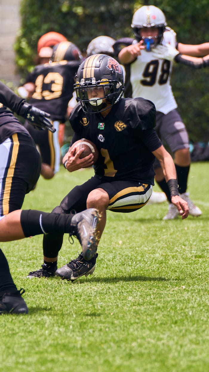 Dynamic action shot of youth football players during an outdoor game, showcasing skill and teamwork.